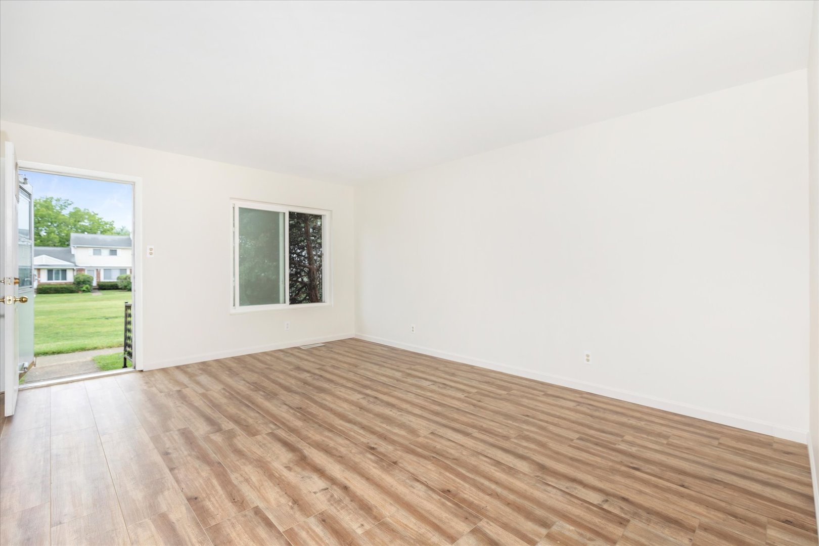 465 Mallview Lane Bolingbrook, IL 60440 - Photo 3 of 26 a view of an empty room with wooden floor and a window