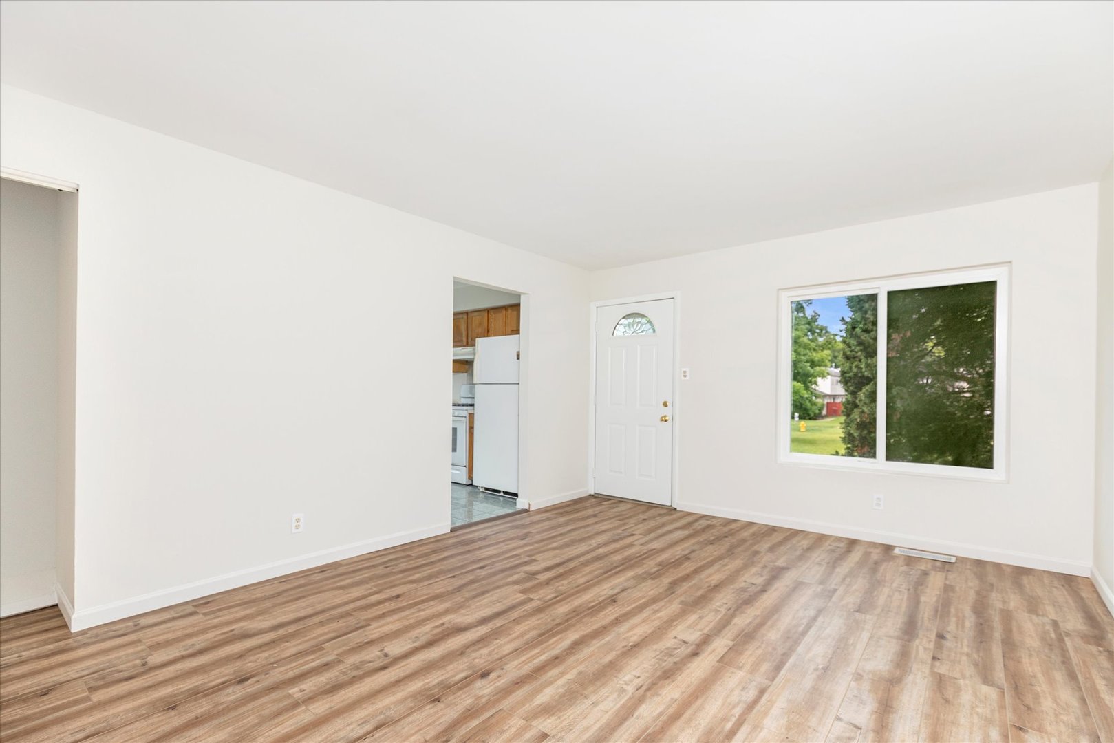 465 Mallview Lane Bolingbrook, IL 60440 - Photo 4 of 26 a view of an empty room with wooden floor and a window