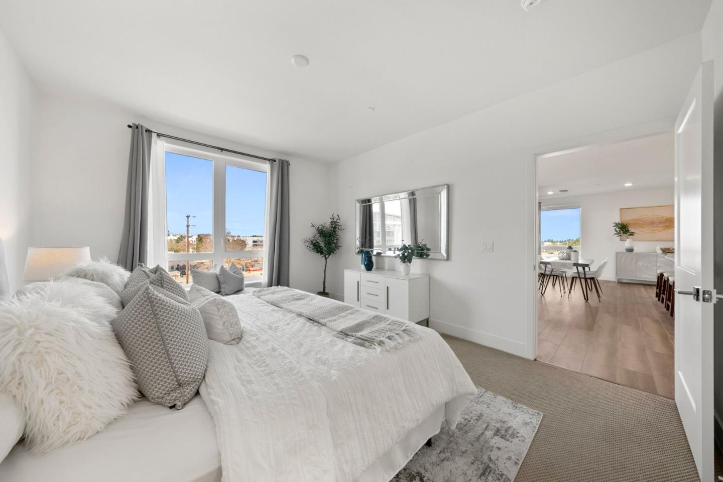 3578 Rambla Place, Unit 311 Santa Clara, CA 95051 - Photo 12 of 48 a large bedroom with a bed and large mirror