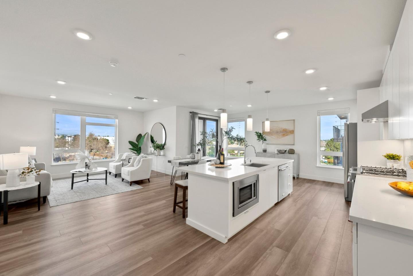 3578 Rambla Place, Unit 311 Santa Clara, CA 95051 - Photo 3 of 48 a large white kitchen with lots of counter top space and living room