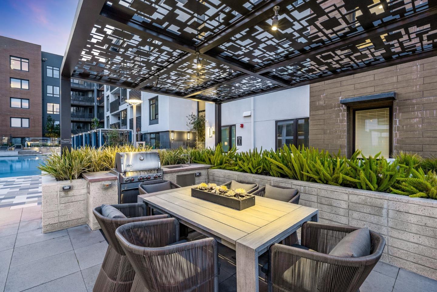 3578 Rambla Place, Unit 311 Santa Clara, CA 95051 - Photo 32 of 48 a roof deck with table and chairs potted plants and barbeque