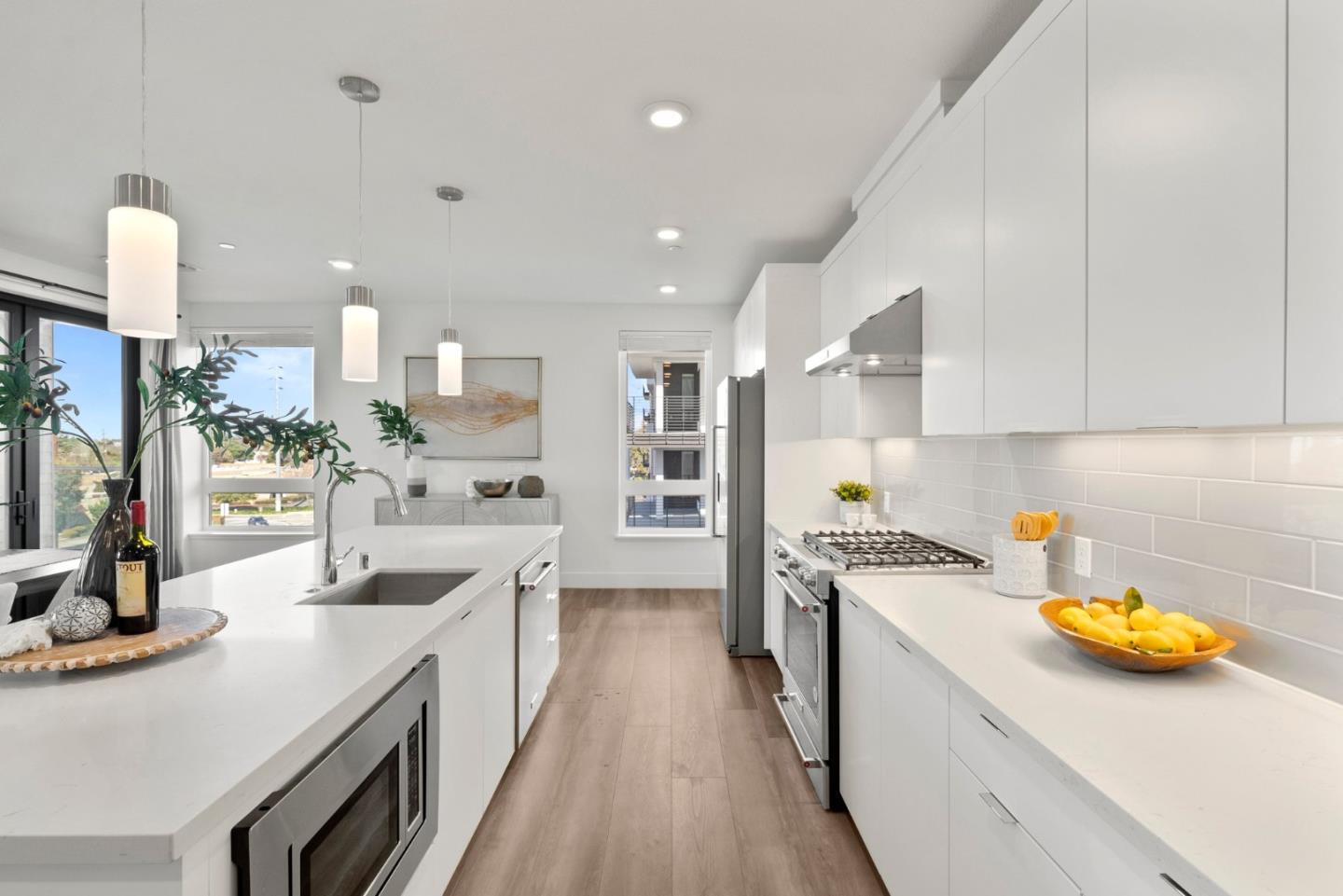 3578 Rambla Place, Unit 311 Santa Clara, CA 95051 - Photo 4 of 48 a kitchen with a sink a stove top oven a stove and white cabinets
