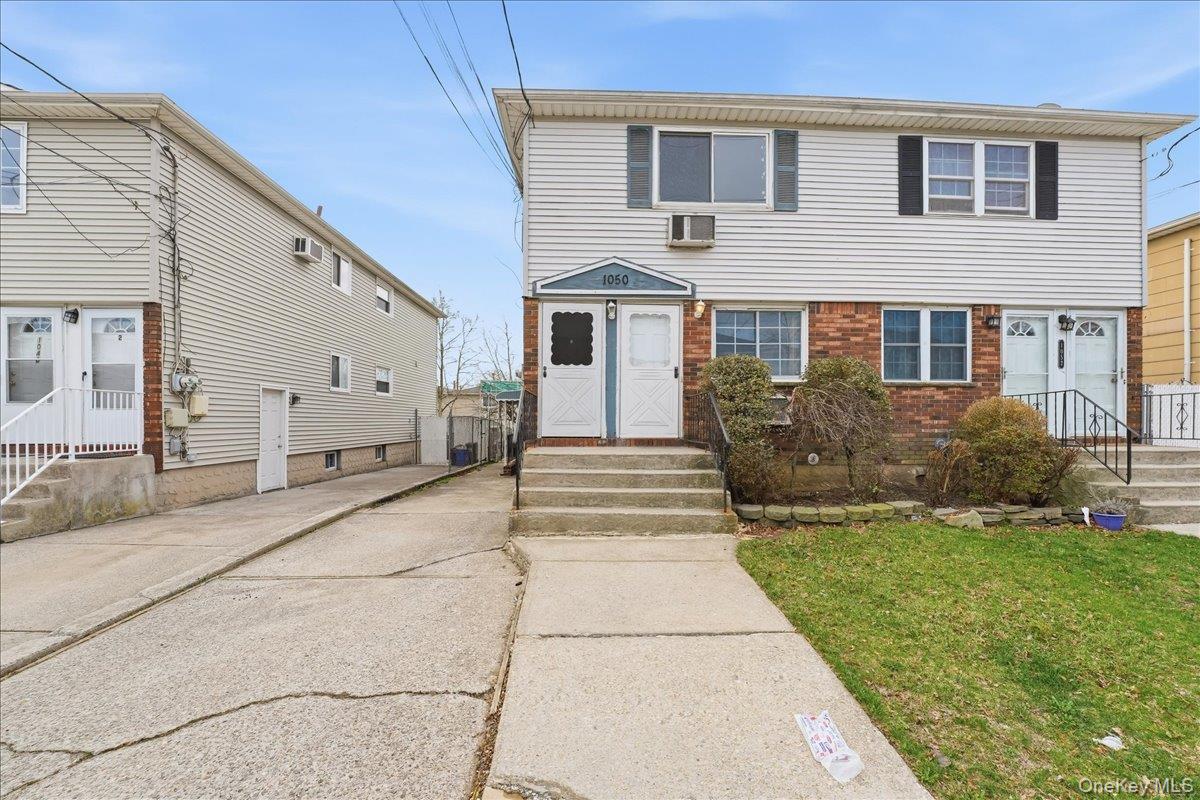 1050 Rensselaer Avenue Staten Island, NY 10309 - Photo 1 of 24 a front view of a house with a garden