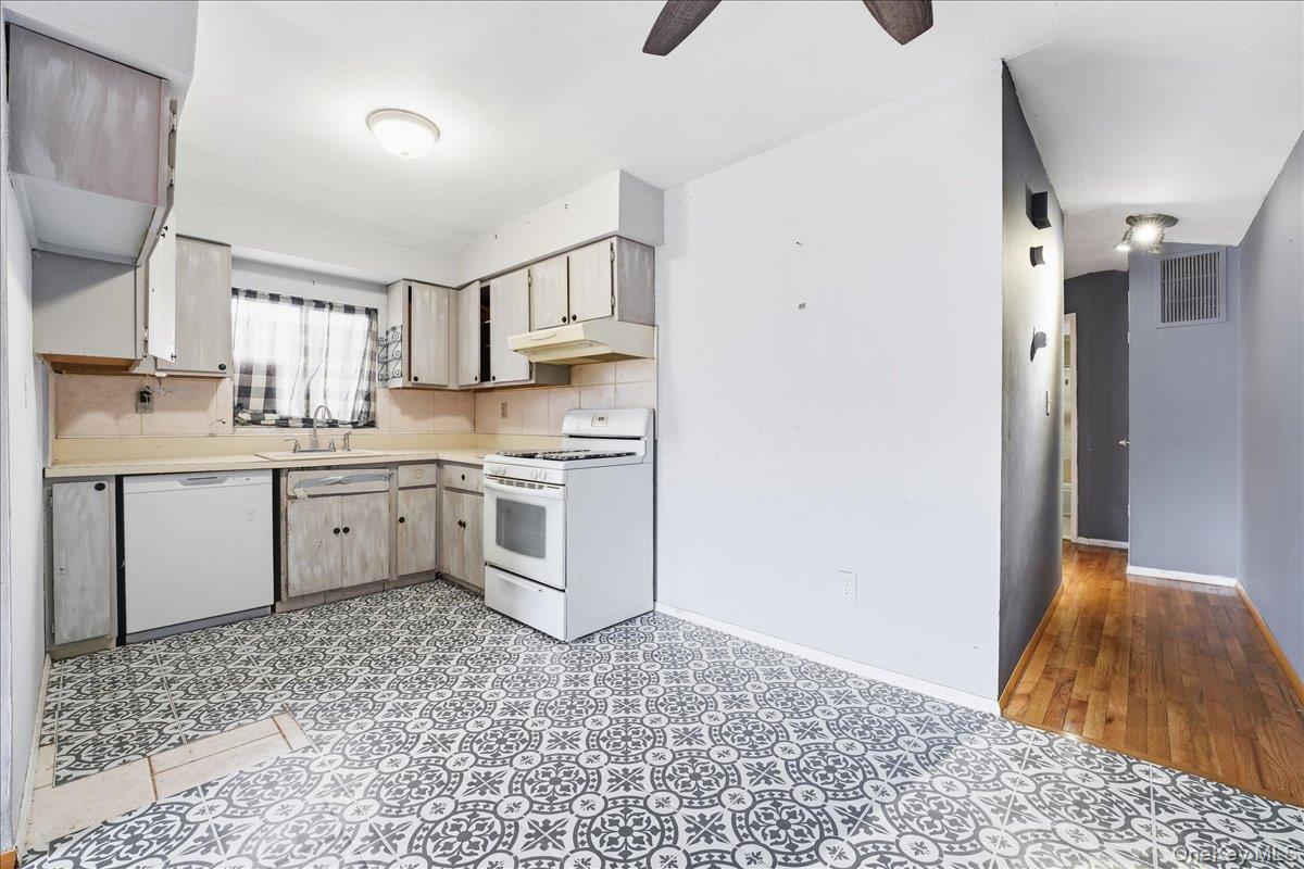 1050 Rensselaer Avenue Staten Island, NY 10309 - Photo 16 of 24 a kitchen with a sink cabinets stainless steel appliances and a window