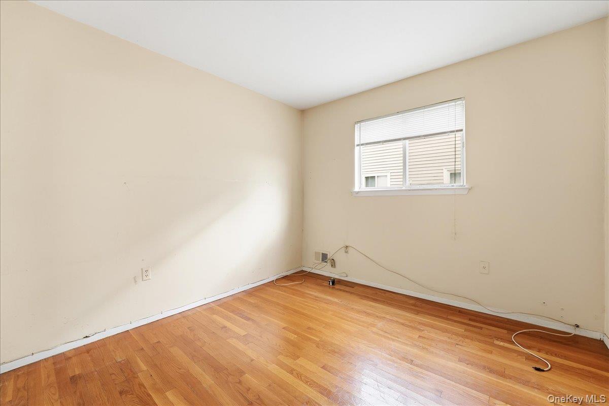 1050 Rensselaer Avenue Staten Island, NY 10309 - Photo 2 of 24 an empty room with wooden floor and windows