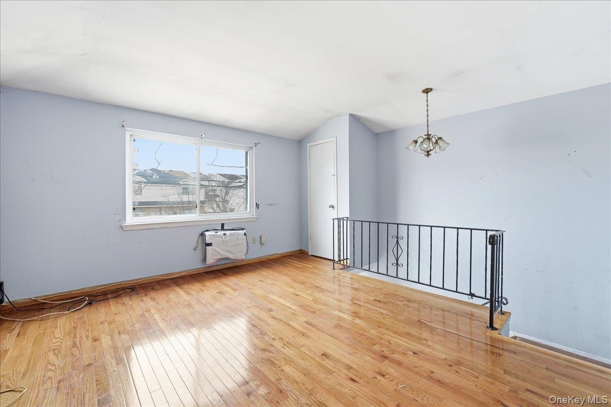 1050 Rensselaer Avenue Staten Island, NY 10309 - Photo 21 of 24 a view of an empty room with a window and wooden floor