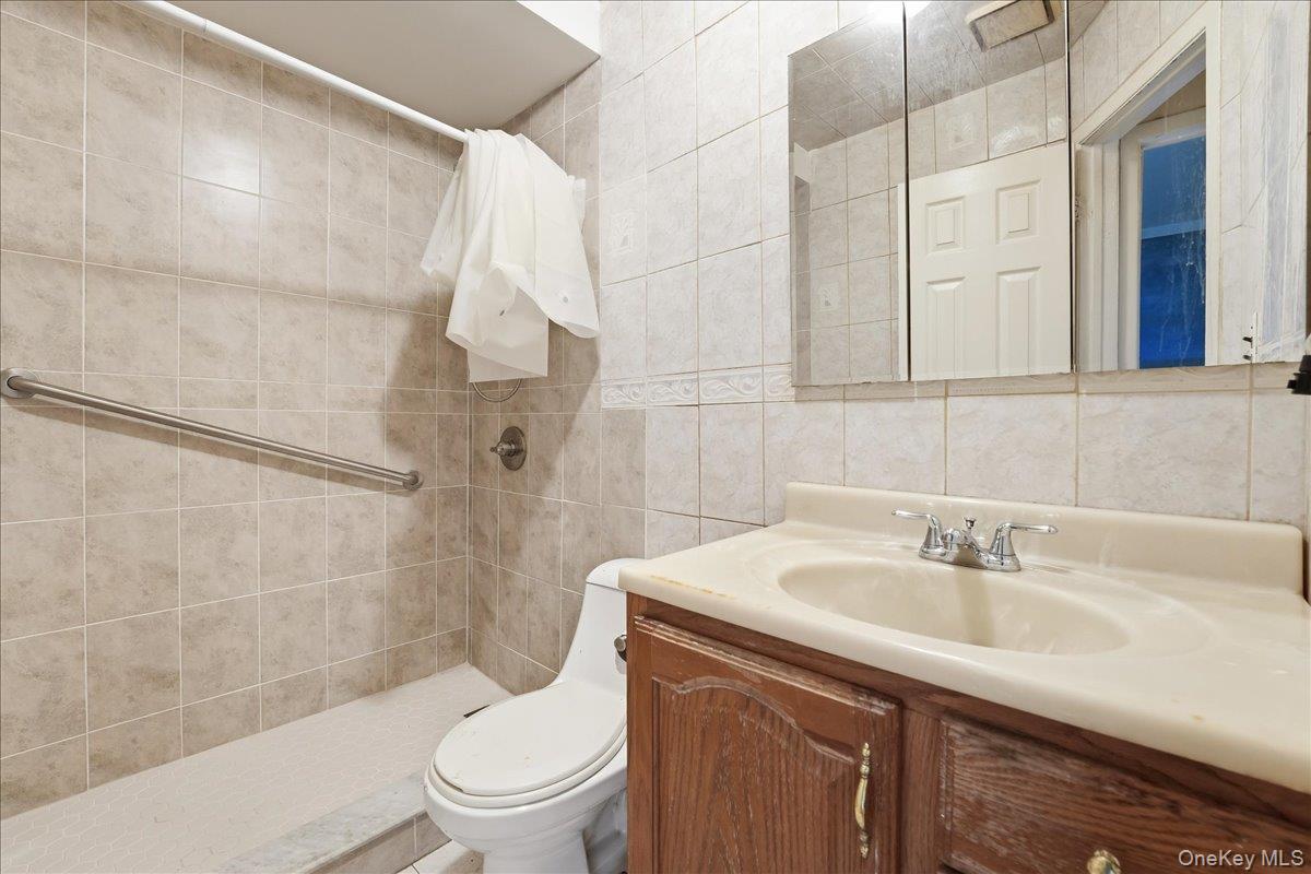 1050 Rensselaer Avenue Staten Island, NY 10309 - Photo 5 of 24 a bathroom with a sink toilet and shower