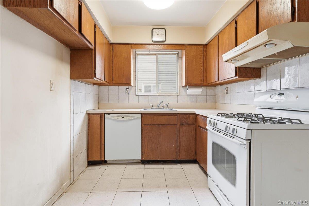 1050 Rensselaer Avenue Staten Island, NY 10309 - Photo 6 of 24 a kitchen with a stove sink and cabinets