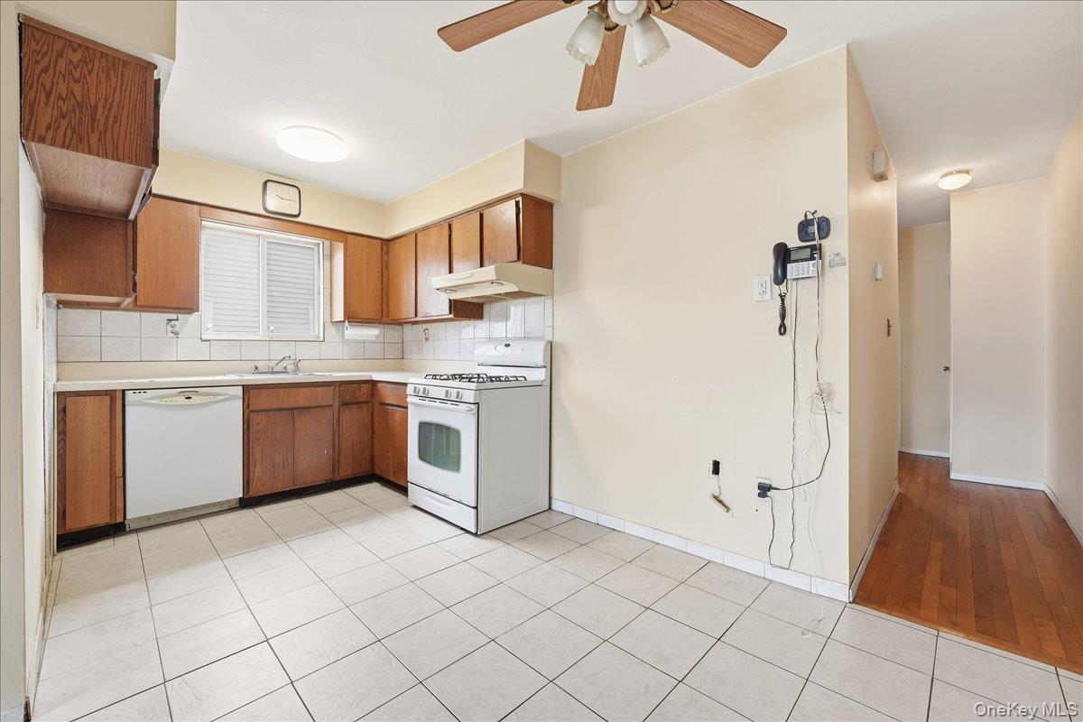 1050 Rensselaer Avenue Staten Island, NY 10309 - Photo 7 of 24 a kitchen with stainless steel appliances a sink and a refrigerator