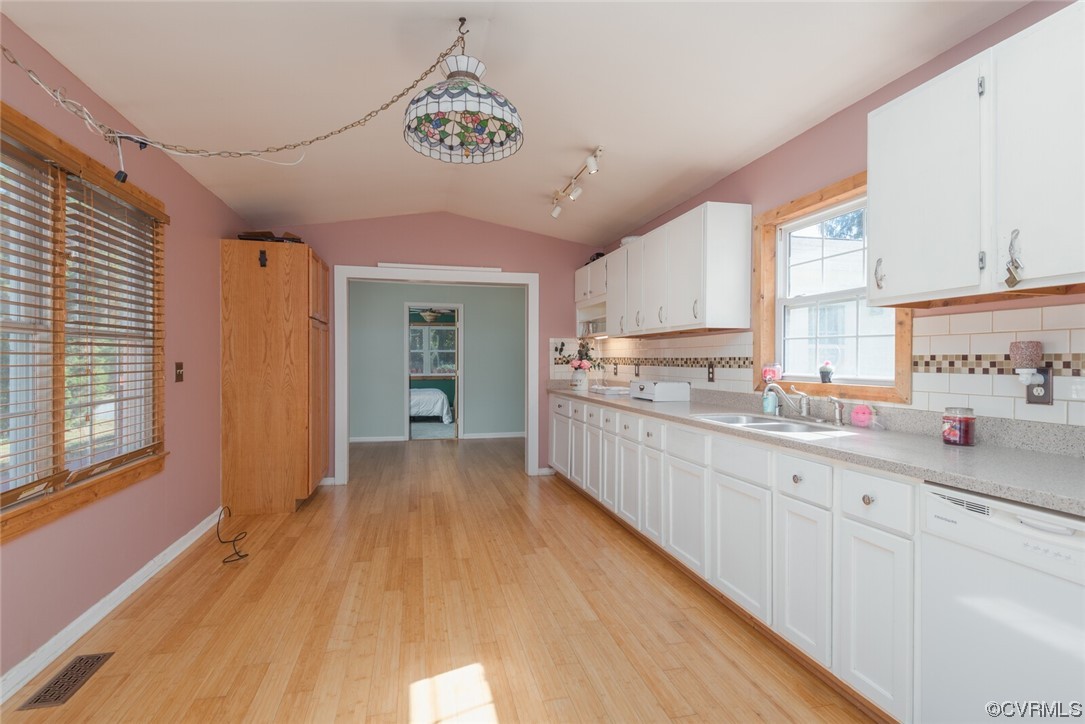 122 Fairview Road Louisa, VA 23093 - Photo 19 of 39 a kitchen with granite countertop a stove a sink and white cabinets with wooden floor