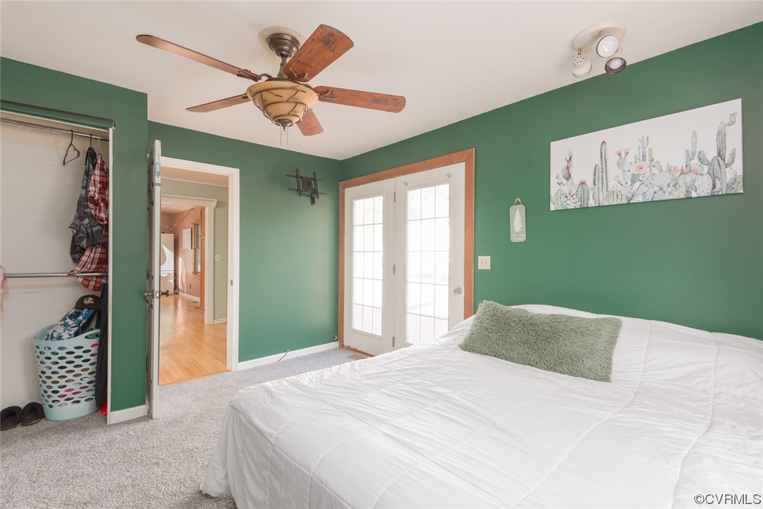 122 Fairview Road Louisa, VA 23093 - Photo 21 of 39 a bedroom with a large bed and a chandelier