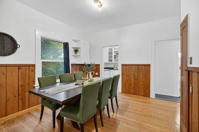a kitchen with stainless steel appliances granite countertop white cabinets sink and window