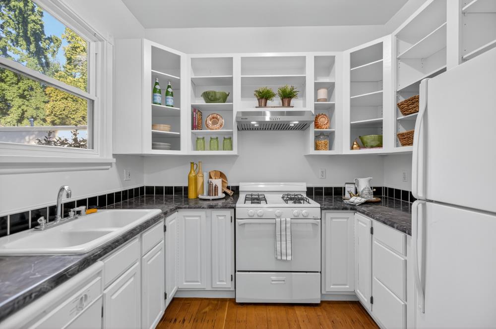 811 18th Street Sacramento, CA 95811 - Photo 15 of 71 a kitchen with stainless steel appliances granite countertop white cabinets sink and window