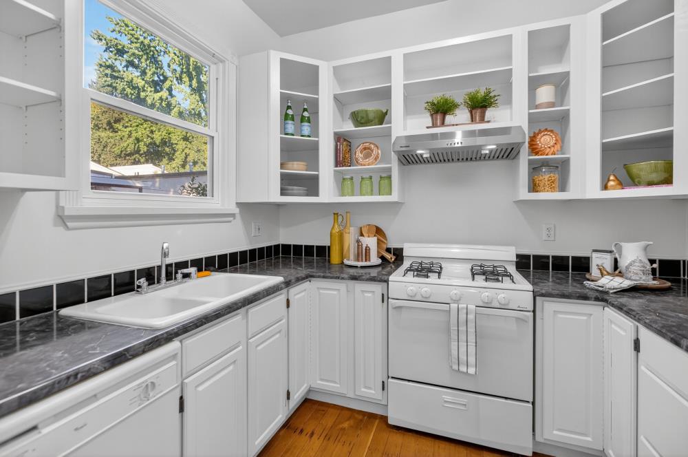 811 18th Street Sacramento, CA 95811 - Photo 16 of 71 a kitchen with stainless steel appliances granite countertop white cabinets sink and window