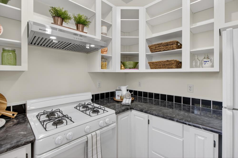 811 18th Street Sacramento, CA 95811 - Photo 17 of 71 a white kitchen with a stove and a white cabinets