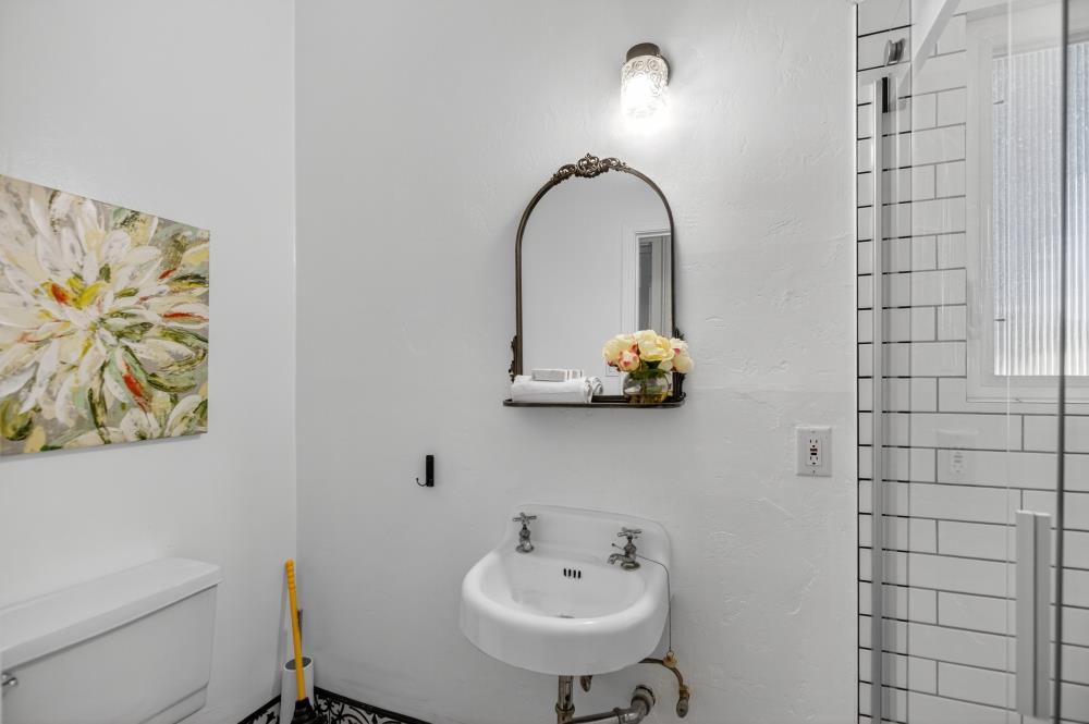 811 18th Street Sacramento, CA 95811 - Photo 18 of 71 a bathroom with a sink mirror and toilet