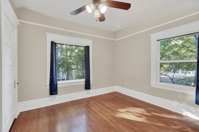 a bedroom with bed and ceiling fan