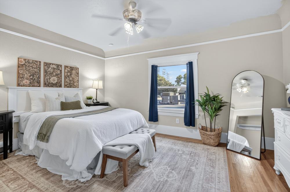 811 18th Street Sacramento, CA 95811 - Photo 34 of 71 a bedroom with a bed and a chandelier