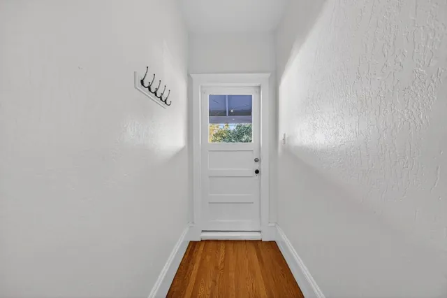 a white kitchen with a table and chairs in it