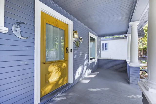 a living room with furniture a fireplace and a table