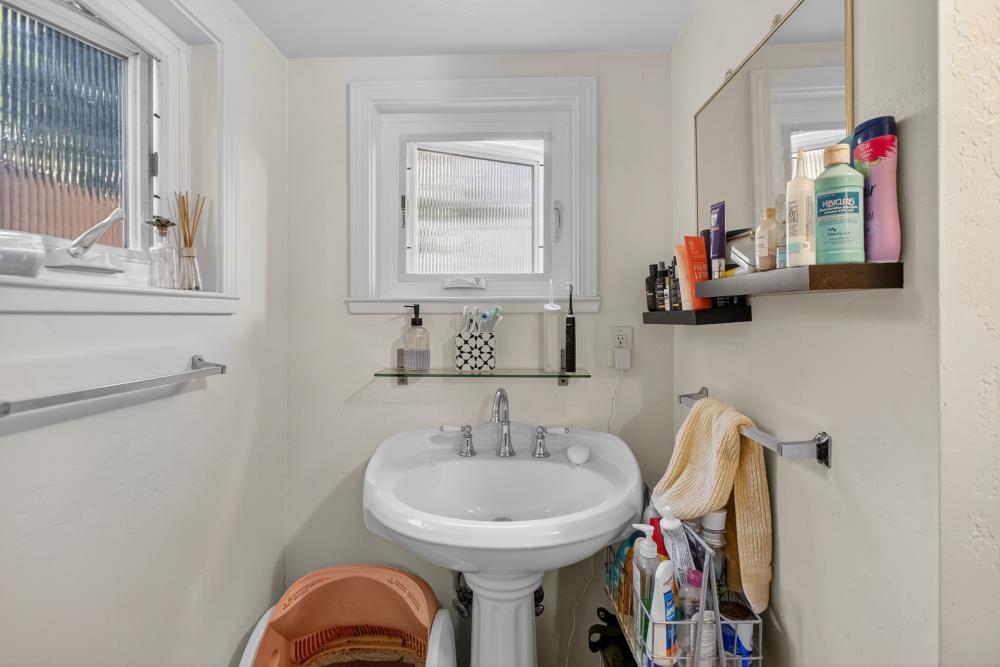 811 18th Street Sacramento, CA 95811 - Photo 60 of 71 a bathroom with a sink and a mirror