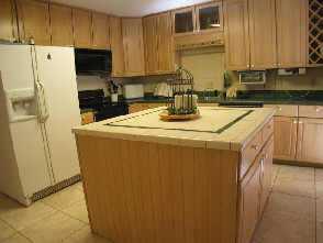 2625 Walker Road Matthews, NC 28105 - Photo 6 of 8 a kitchen with stainless steel appliances granite countertop a sink a stove a refrigerator a washer and dryer with wooden floor