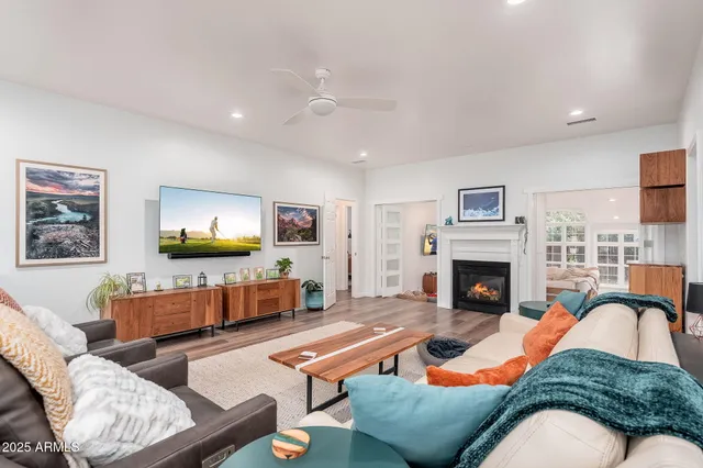 a living room with furniture fireplace and window
