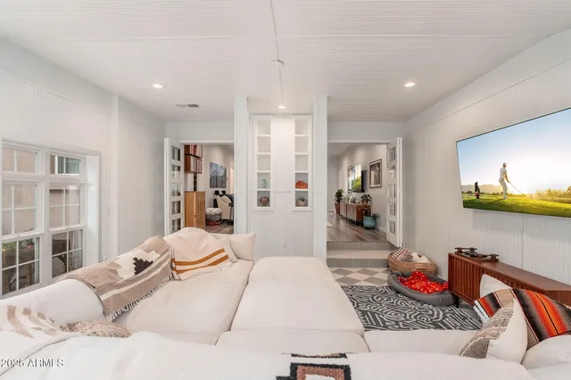 a bedroom with a bed and glass window