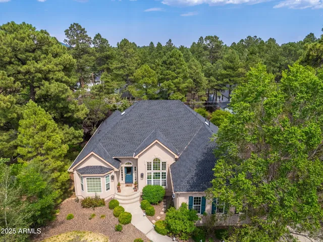 an aerial view of a house with yard swimming pool and outdoor seating