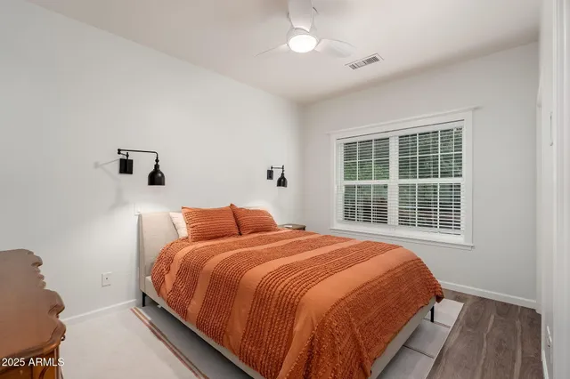 an aerial view of a house with a yard and a large tree