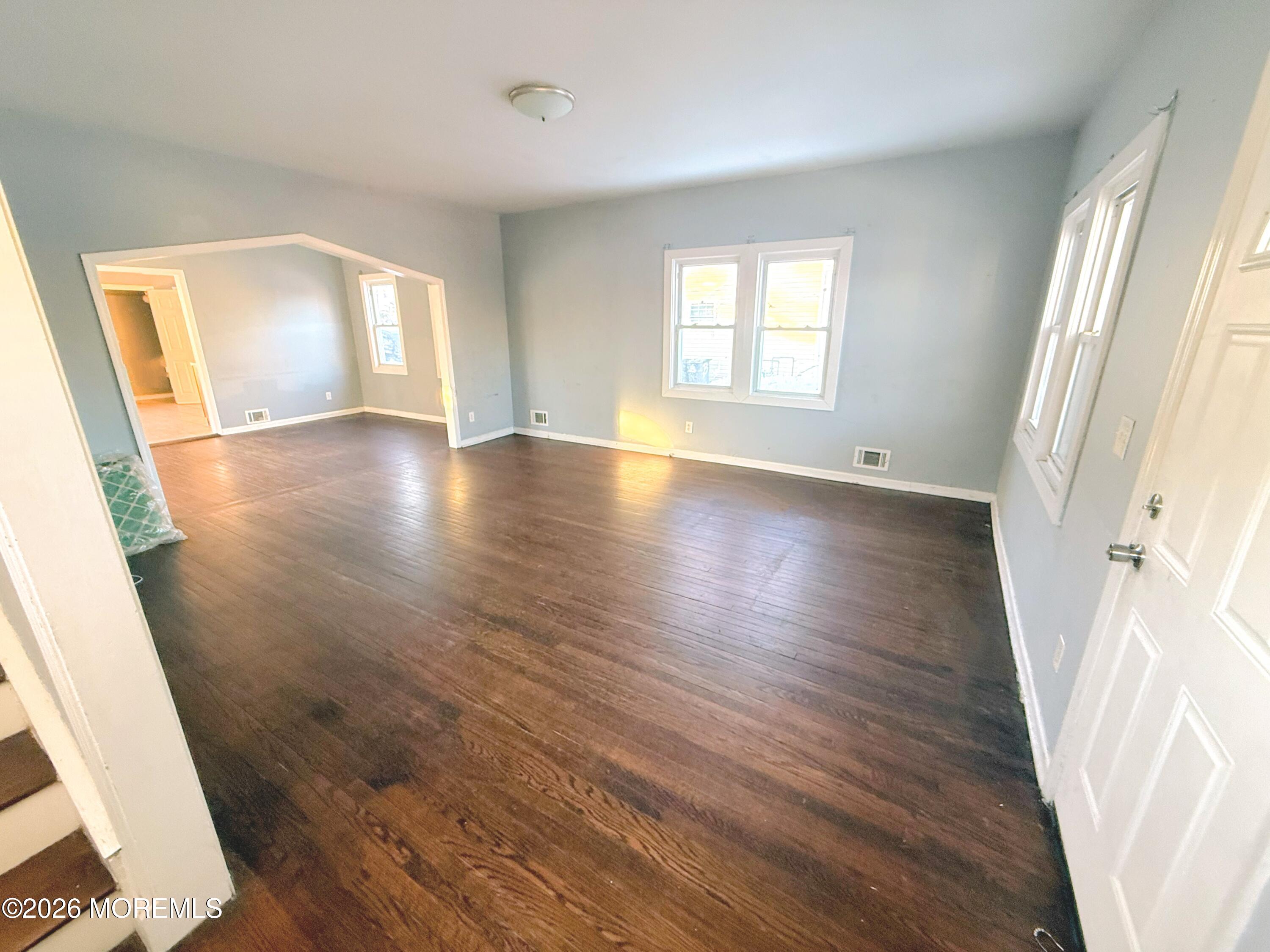 401 Ridge Avenue Asbury Park, NJ 07712 - Photo 2 of 11 an empty room with wooden floor and windows