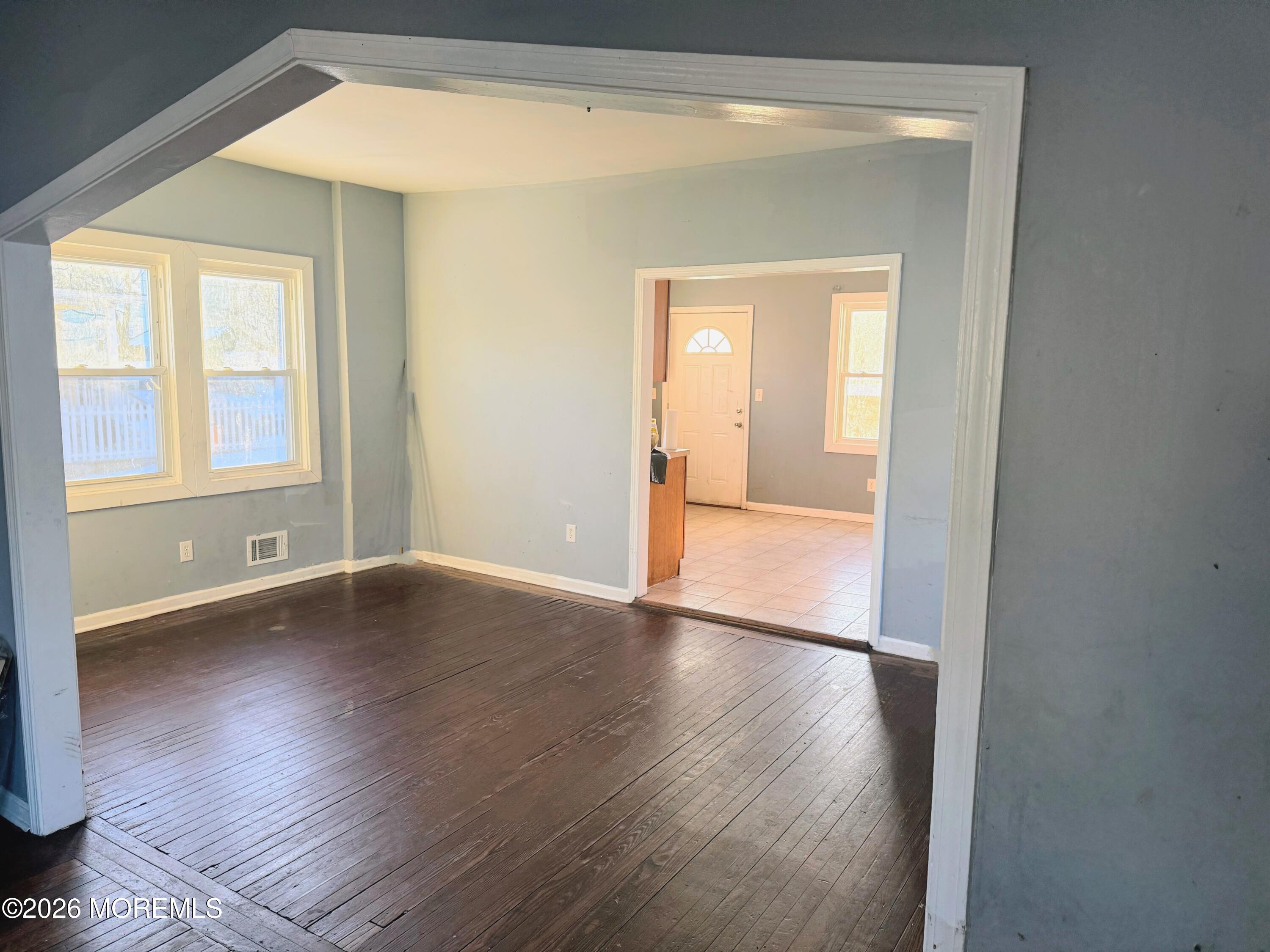 401 Ridge Avenue Asbury Park, NJ 07712 - Photo 4 of 11 a view of an empty room with wooden floor and a window