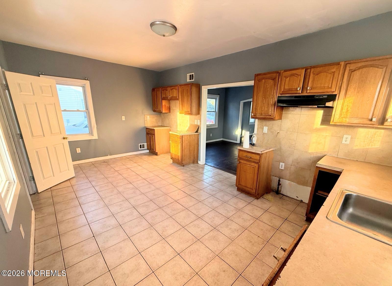 401 Ridge Avenue Asbury Park, NJ 07712 - Photo 5 of 11 a bathroom with a sink a toilet and mirror