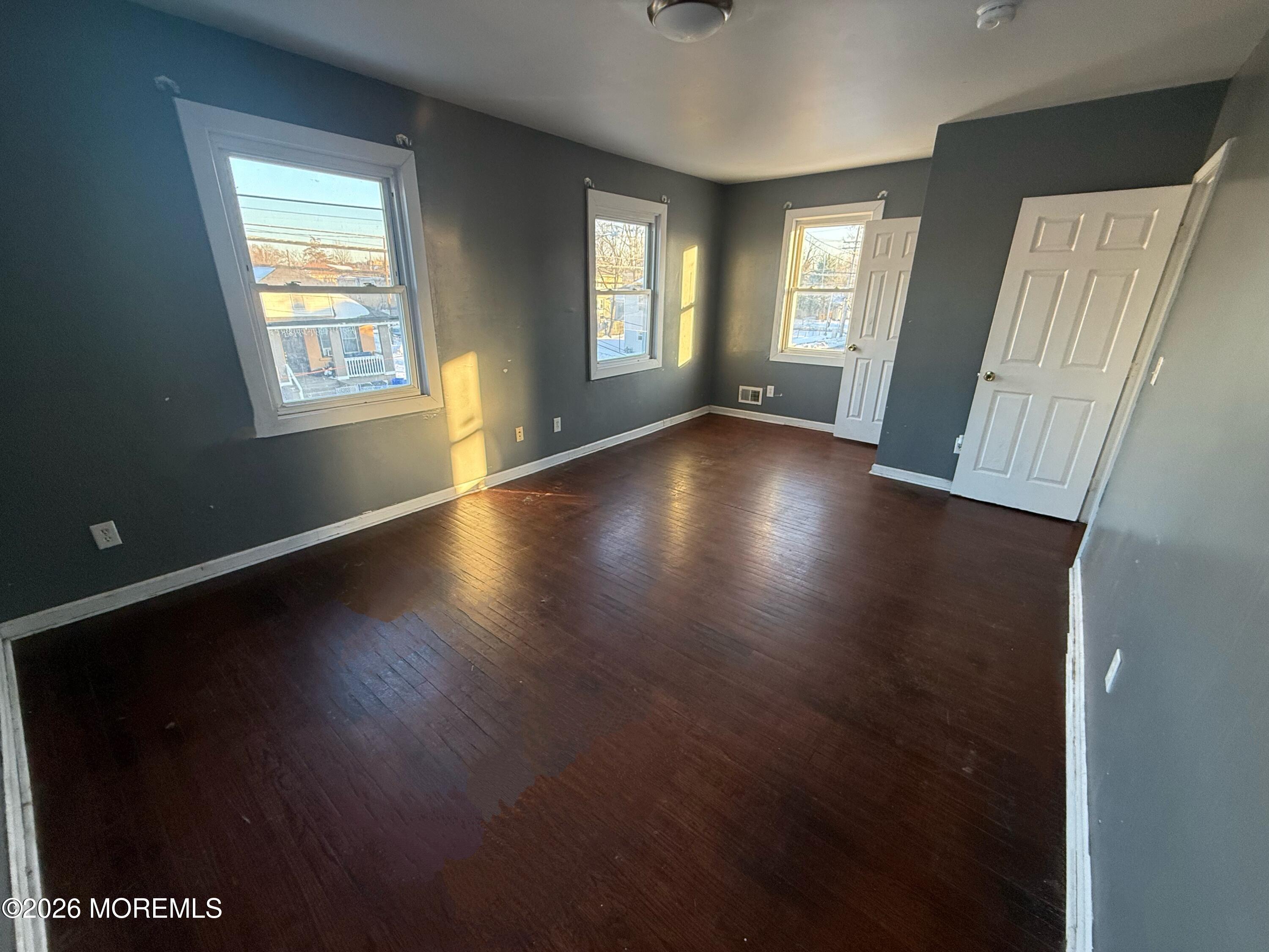 401 Ridge Avenue Asbury Park, NJ 07712 - Photo 6 of 11 a view of an empty room with wooden floor and a window