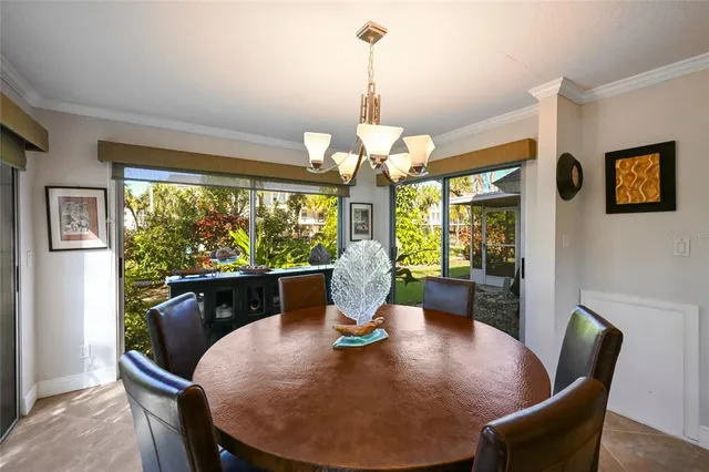a view of a dining room with furniture a chandelier and wooden floor