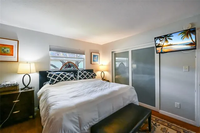 a bedroom with a bed and dresser with mirror