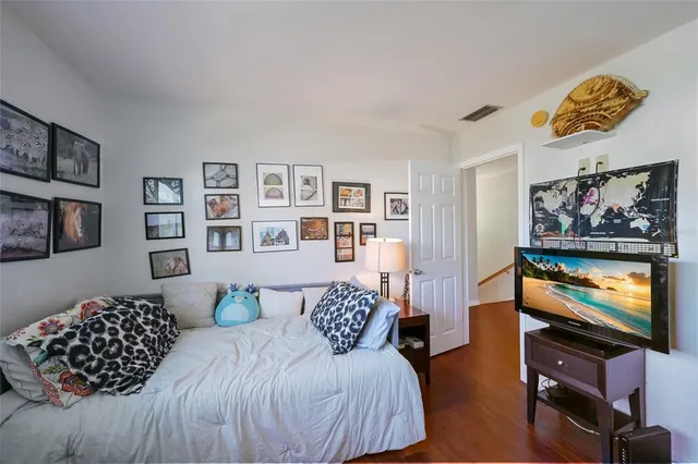 a bedroom with furniture and a flat screen tv