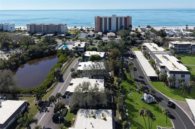 an aerial view of a house with a yard basket ball court and outdoor seating