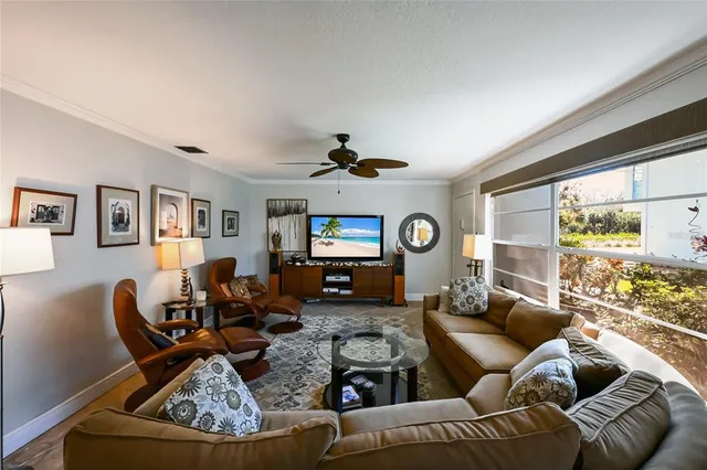 a living room with furniture a large window and a fireplace