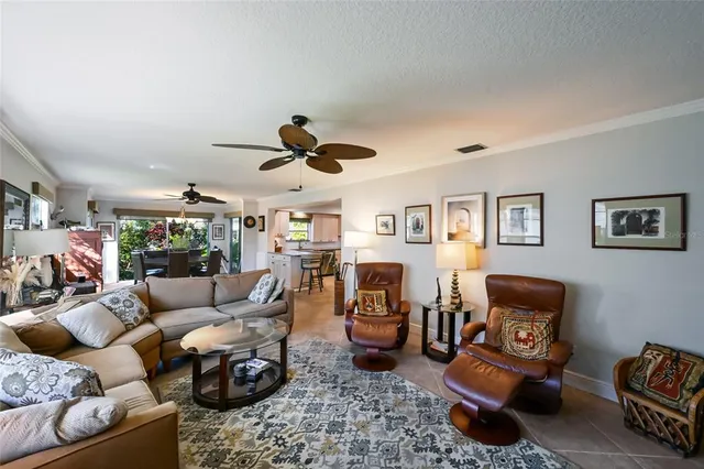 a living room with furniture and a ceiling fan