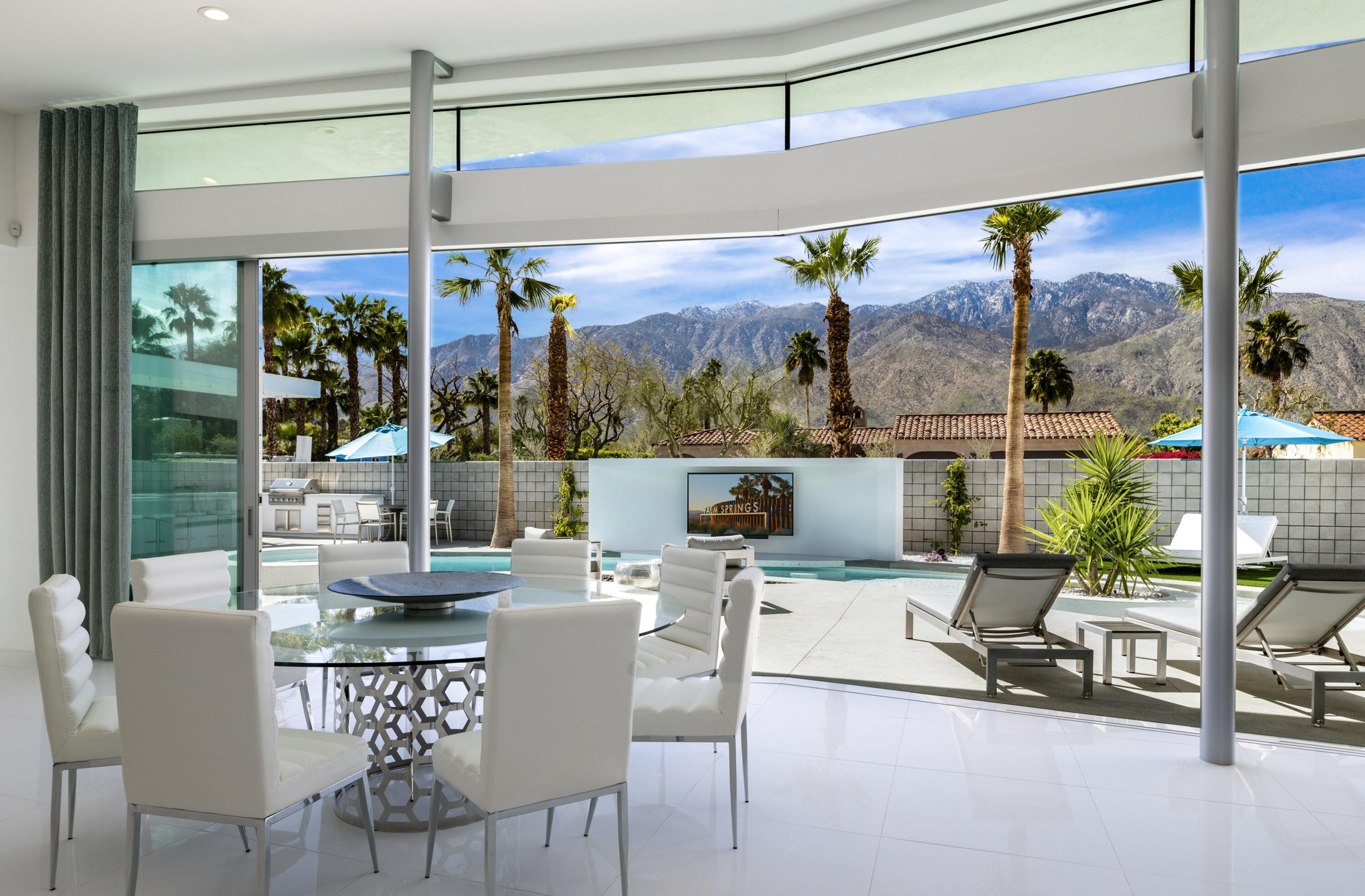 2696 Anza Trail Palm Springs, CA 92264 - Photo 21 of 99 a view of a dining room with furniture wooden floor and a chandelier