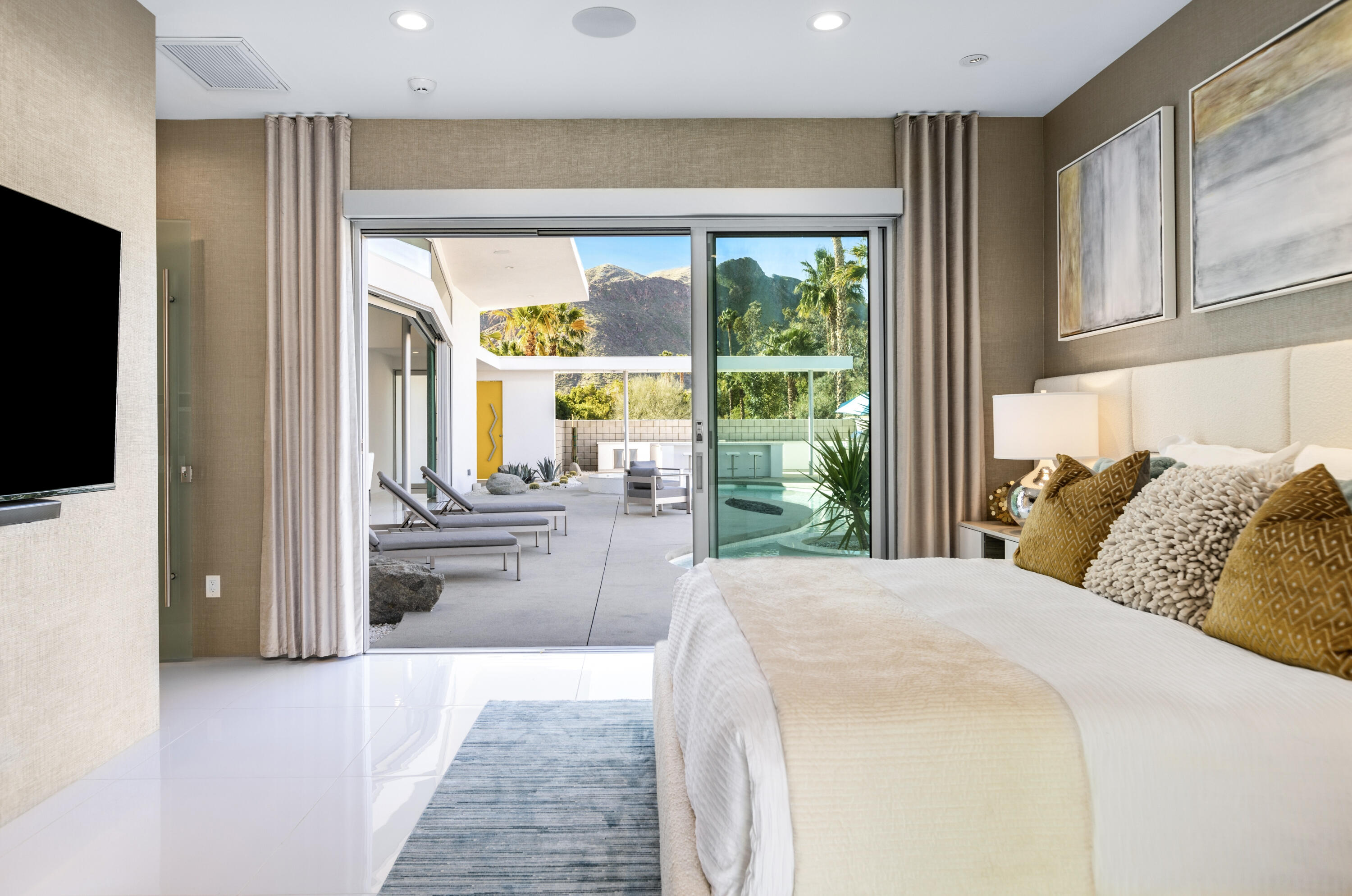 2696 Anza Trail Palm Springs, CA 92264 - Photo 43 of 99 a large bedroom with a large bed and a flat tv screen