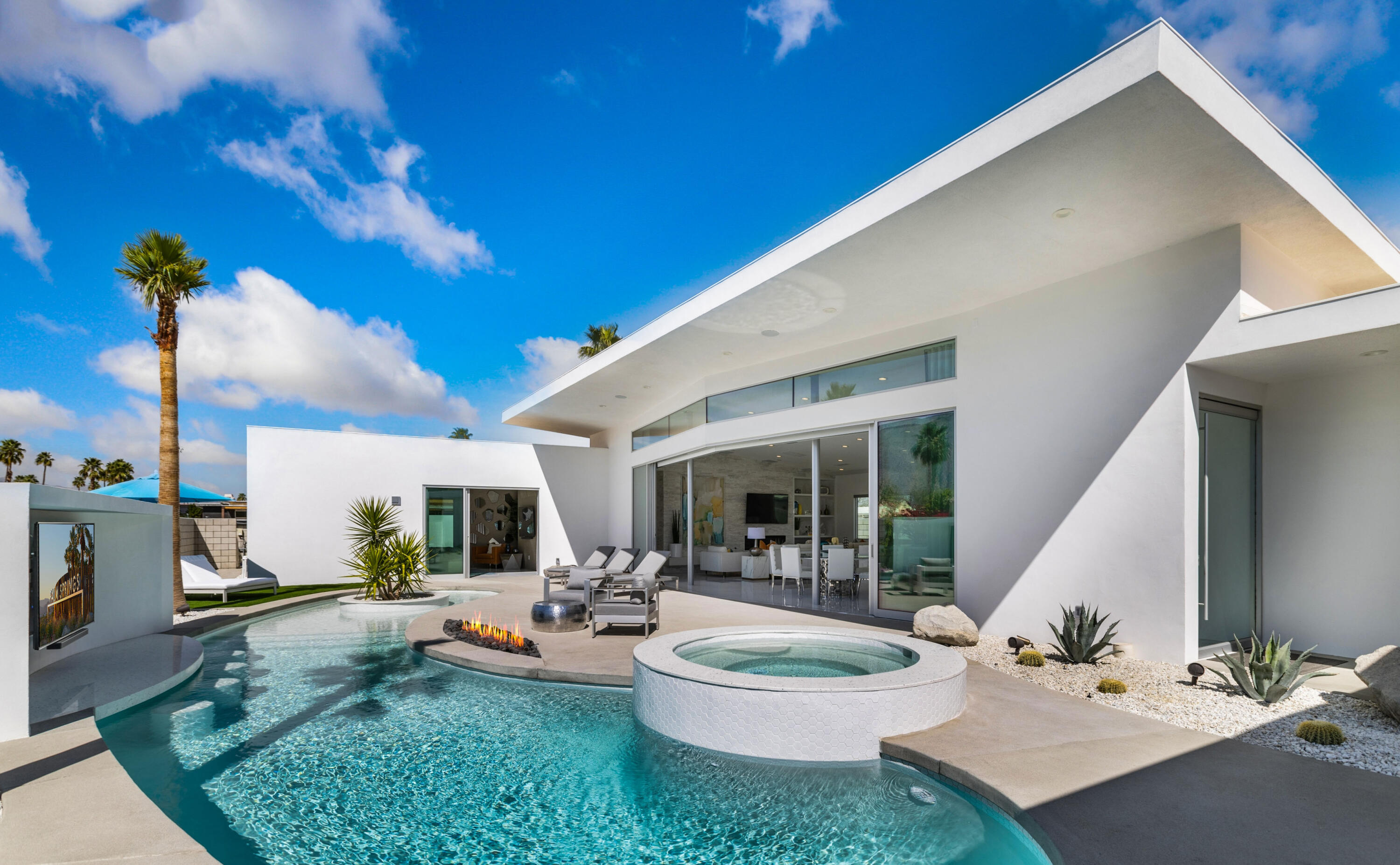 2696 Anza Trail Palm Springs, CA 92264 - Photo 48 of 99 a living room with patio furniture and a potted plant