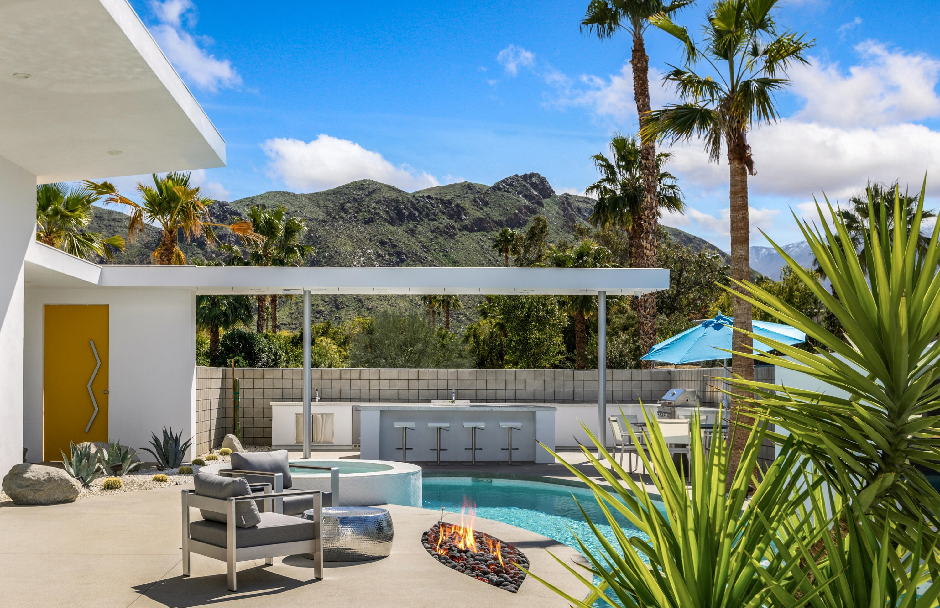 2696 Anza Trail Palm Springs, CA 92264 - Photo 56 of 99 a backyard of a house with table and chairs plants