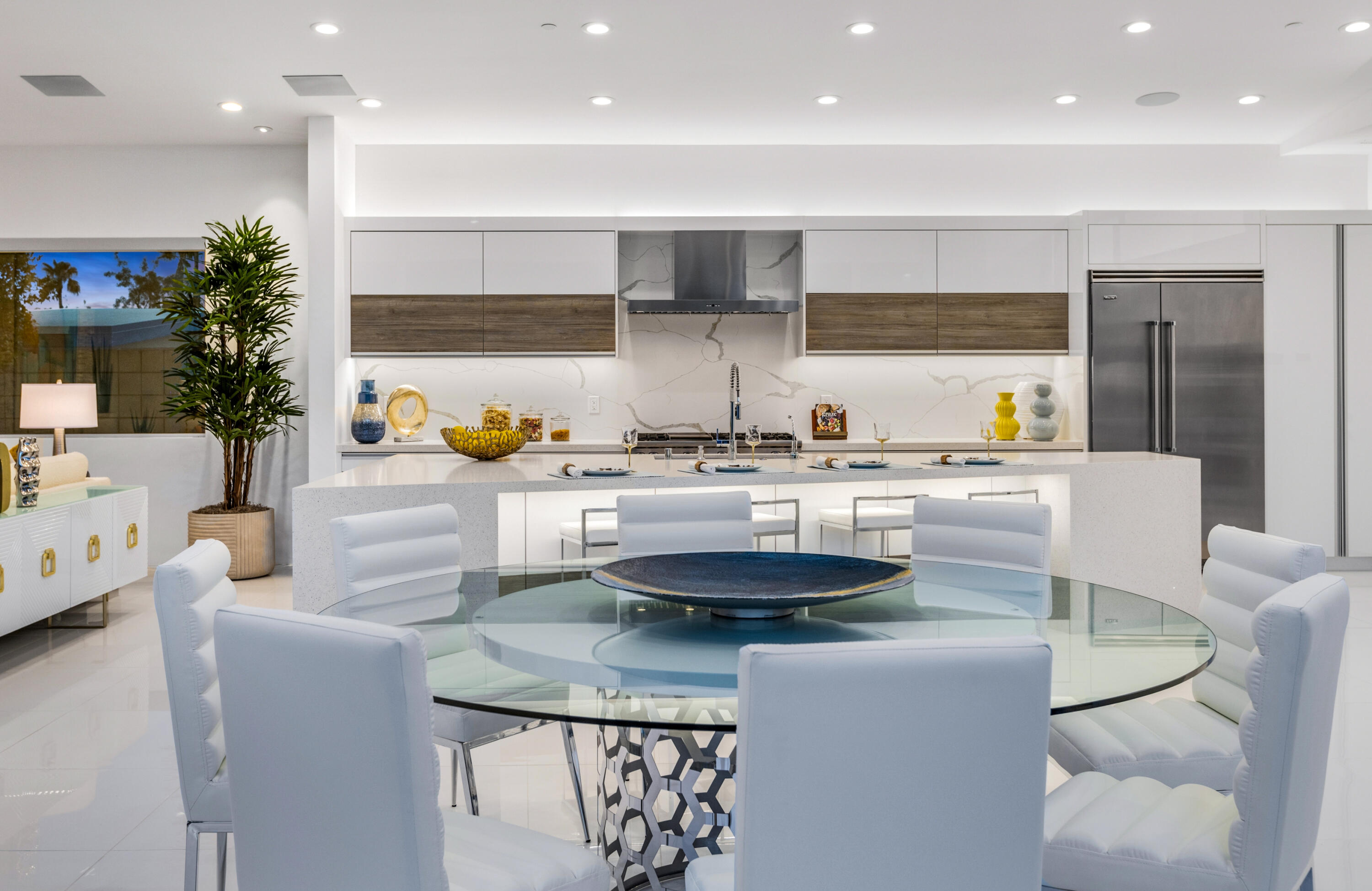 2696 Anza Trail Palm Springs, CA 92264 - Photo 77 of 99 a kitchen with kitchen island stainless steel appliances a sink a stove a table and chairs
