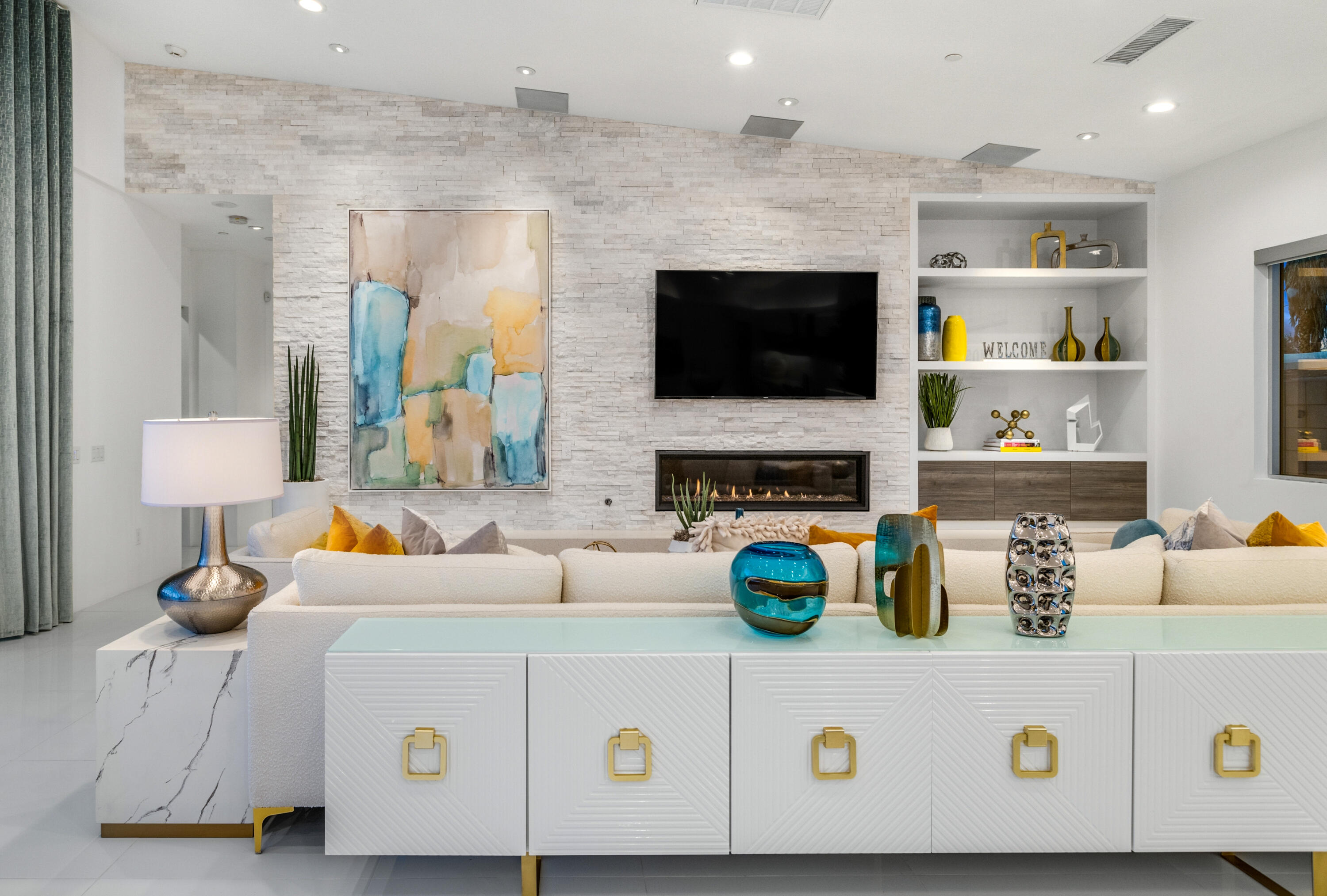 2696 Anza Trail Palm Springs, CA 92264 - Photo 79 of 99 a living room with a couch a flat screen tv and a fireplace