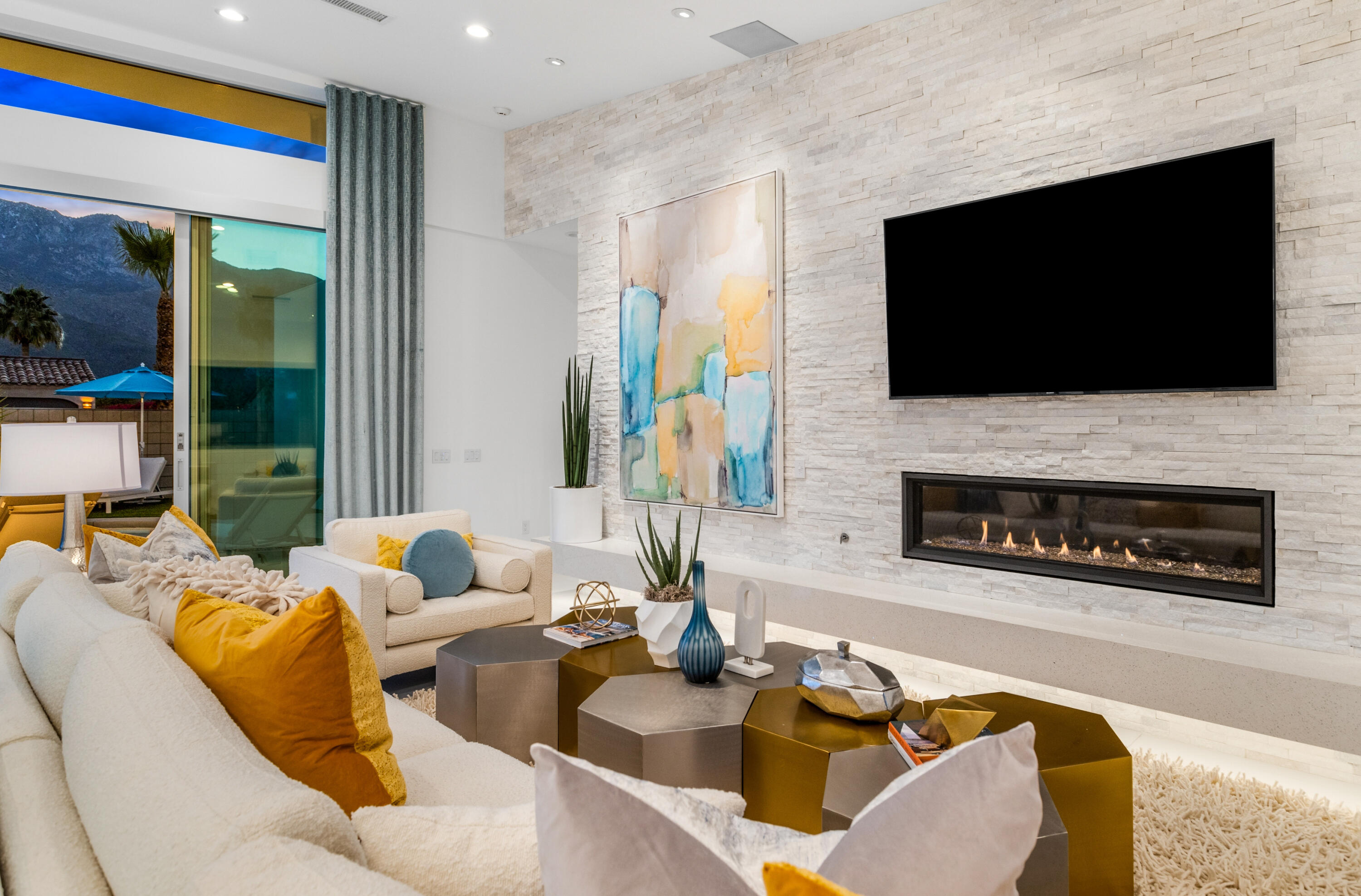 2696 Anza Trail Palm Springs, CA 92264 - Photo 81 of 99 a living room with furniture a flat screen tv and a fireplace