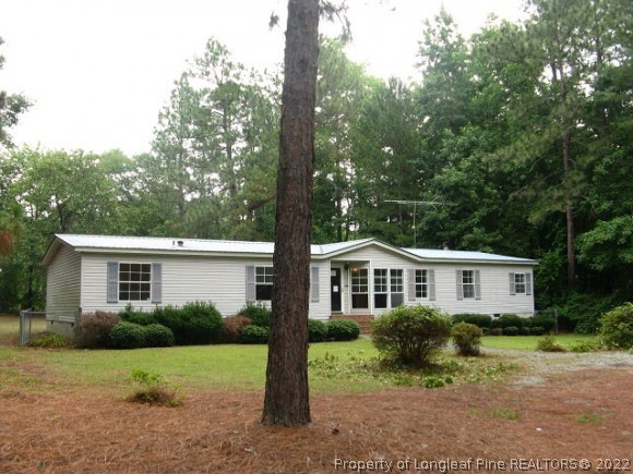 120 Westview Road Carthage, NC 28327 - Photo 1 of 11 a front view of a house with a yard and trees