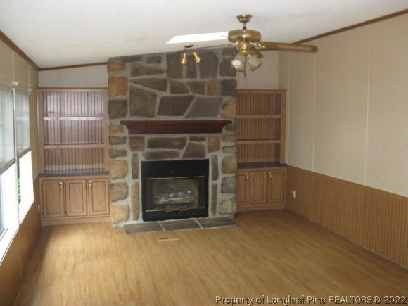 120 Westview Road Carthage, NC 28327 - Photo 4 of 11 a room with a fireplace and a wooden floor