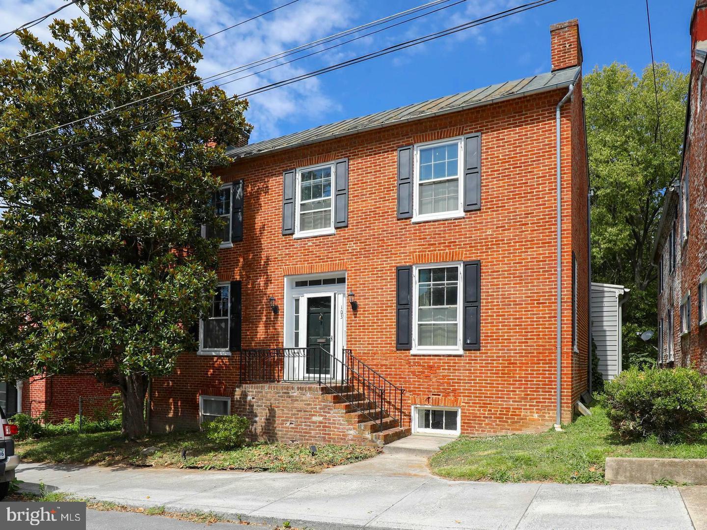 103 North Church Street Berryville, VA 22611 - Photo 1 of 13 a front view of a house with a yard and tree